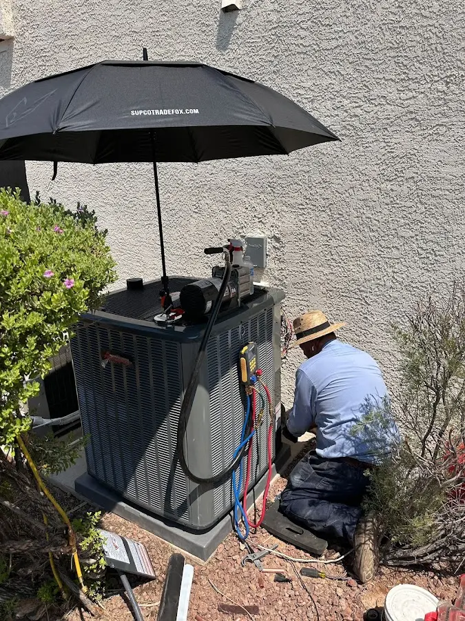 HVAC technician performing outdoor AC maintenance in Shoreview