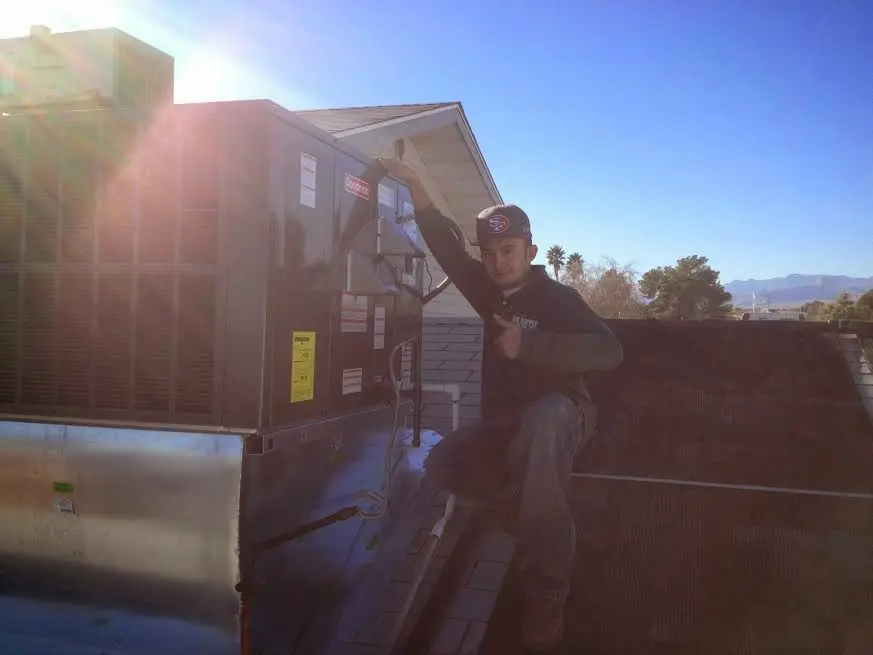 HVAC technician performing HVAC Inspection on a rooftop unit in Shoreview